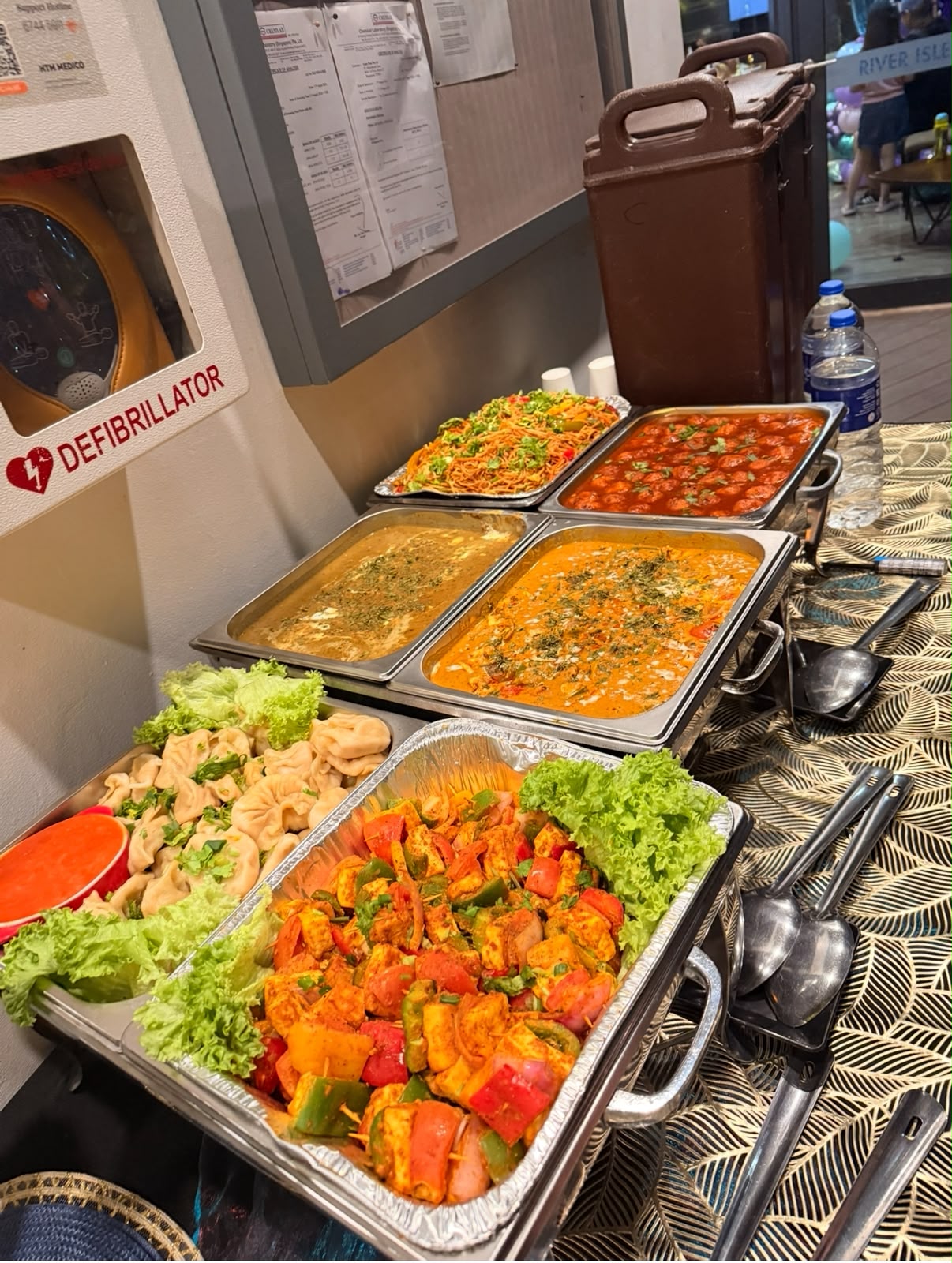 Desichatore catering buffet — chafing trays of noodles, curries, momos and paneer tikka